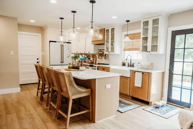 Falling Waters, WV kitchen with white KraftMaid cabinets, wood-tone island with seating, glass pendant lights and a French door